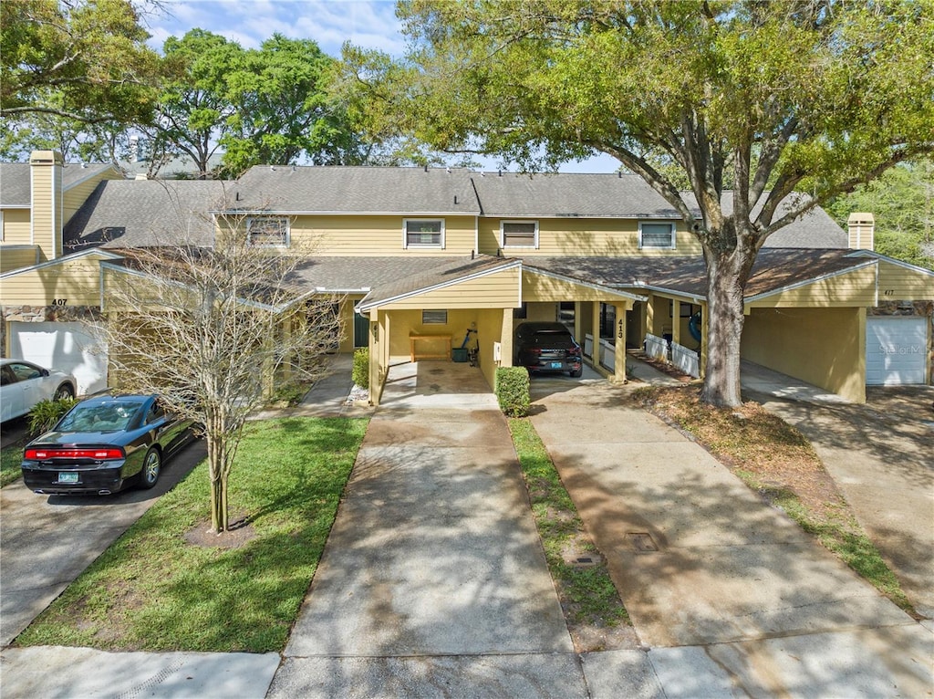 view of front of property featuring a carport and a front lawn