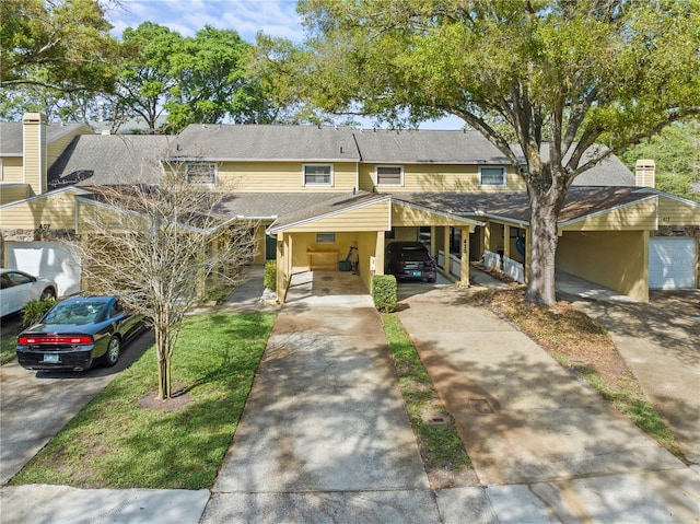 view of front of property featuring a carport and a front lawn