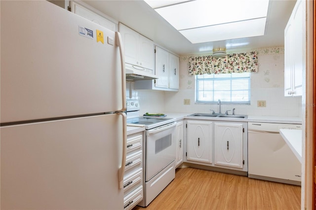 kitchen featuring white appliances, white cabinets, sink, and light hardwood / wood-style flooring