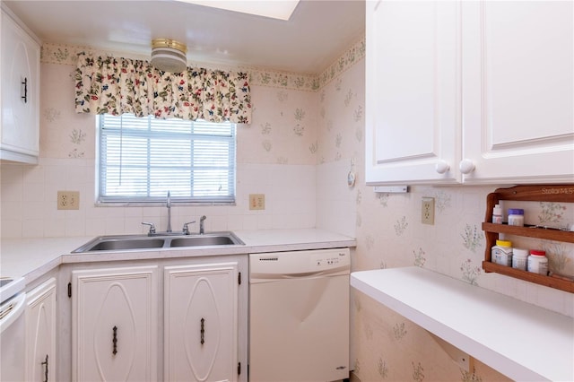 kitchen featuring backsplash, sink, white cabinets, dishwasher, and stove