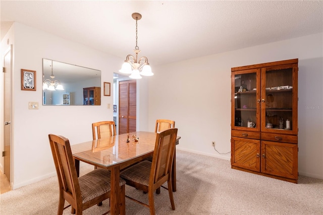 carpeted dining area with a notable chandelier