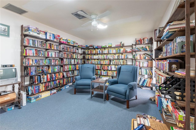 sitting room with dark colored carpet