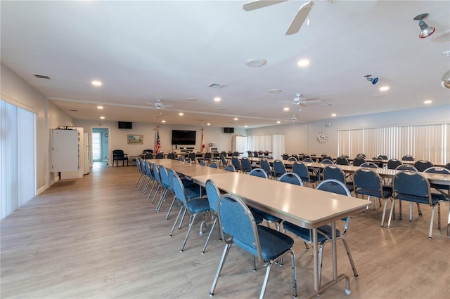 dining room with ceiling fan and light wood-type flooring