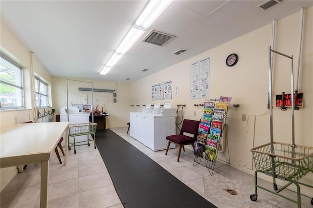 interior space featuring light tile flooring and independent washer and dryer