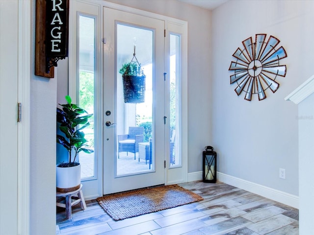 entrance foyer featuring light wood-type flooring and a healthy amount of sunlight