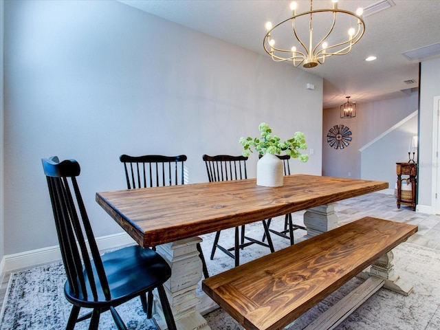 dining room featuring light hardwood / wood-style floors and an inviting chandelier