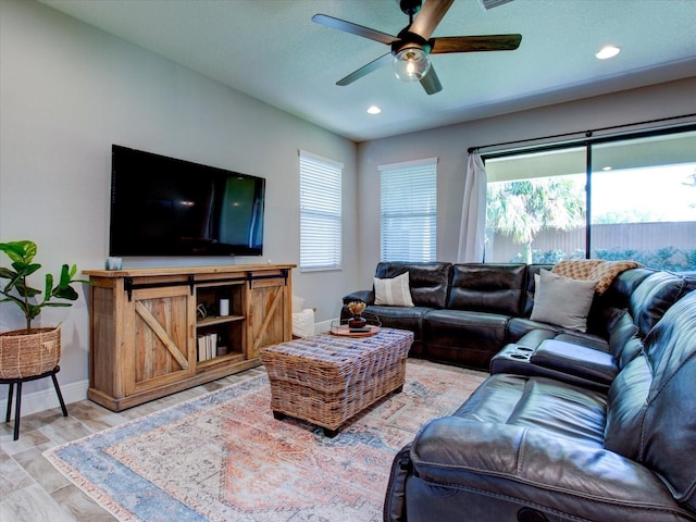 living room featuring hardwood / wood-style floors, plenty of natural light, and ceiling fan