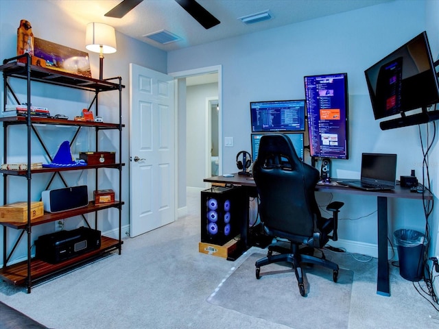 carpeted office space featuring ceiling fan