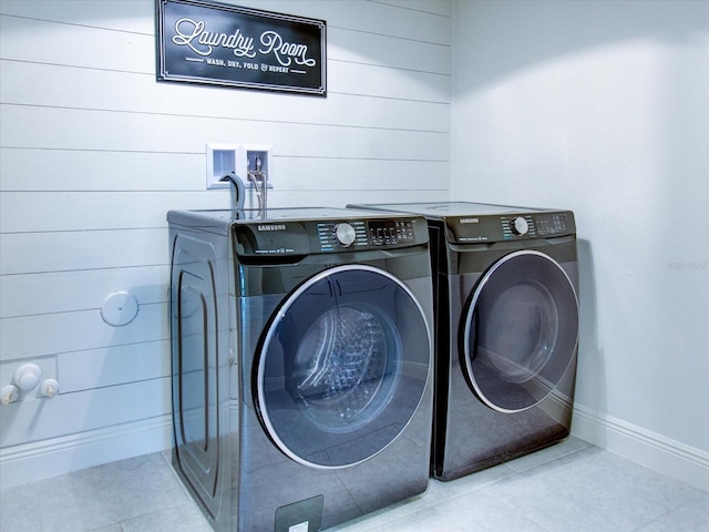 laundry room featuring independent washer and dryer and light tile patterned floors