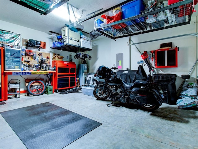 garage featuring a workshop area, electric panel, and a garage door opener