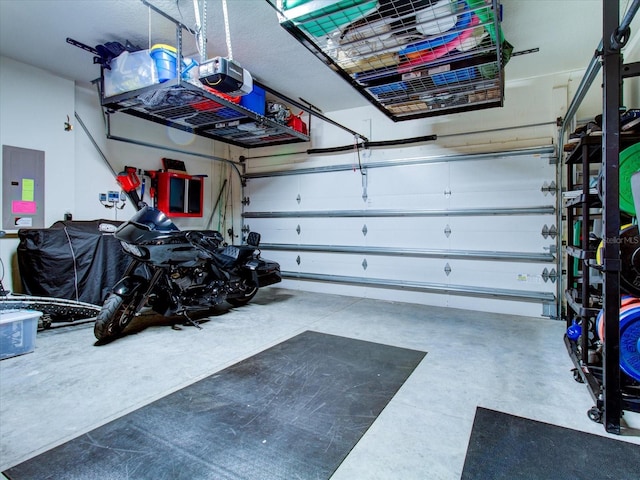 garage featuring electric panel and a garage door opener