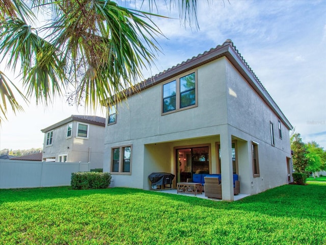 rear view of house featuring outdoor lounge area, a yard, and a patio