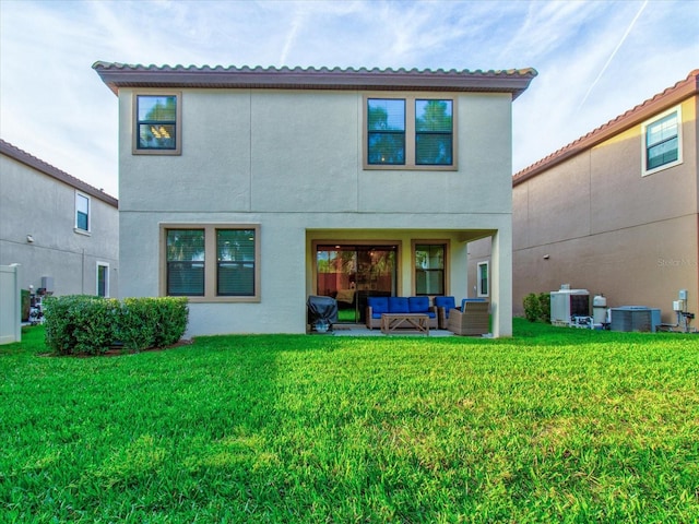 rear view of property with a lawn, central air condition unit, and an outdoor living space