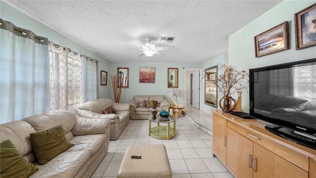 living room featuring a textured ceiling, ceiling fan, and light tile floors