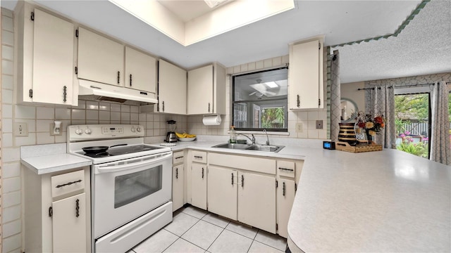 kitchen with backsplash, light tile flooring, sink, a textured ceiling, and white electric range