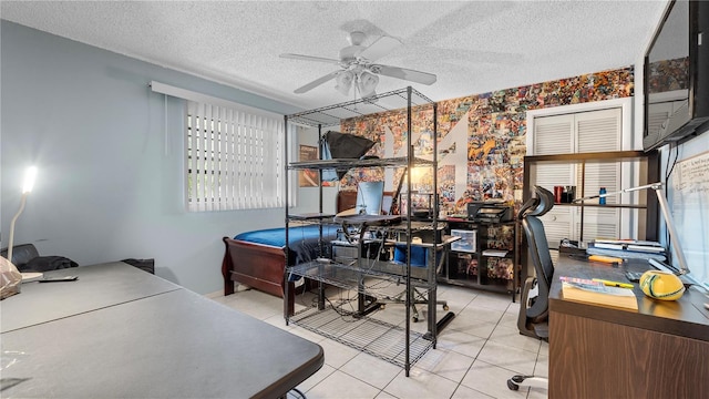 tiled home office featuring ceiling fan and a textured ceiling