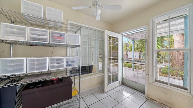 doorway to outside with light tile flooring and ceiling fan