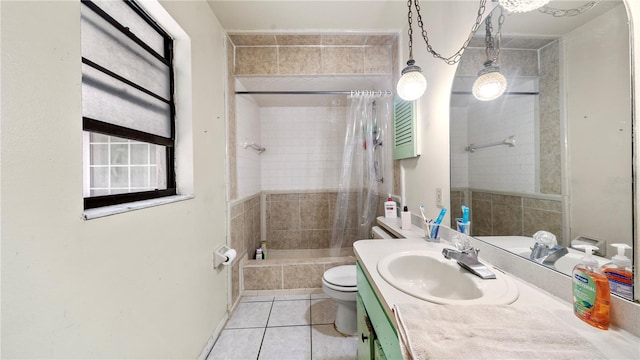 full bathroom featuring toilet, vanity with extensive cabinet space, tile flooring, and shower / bath combination with curtain