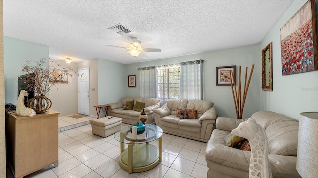 tiled living room featuring a textured ceiling and ceiling fan