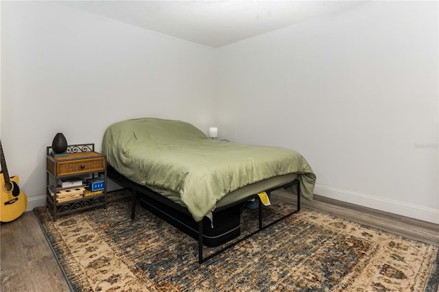 bedroom with wood-type flooring