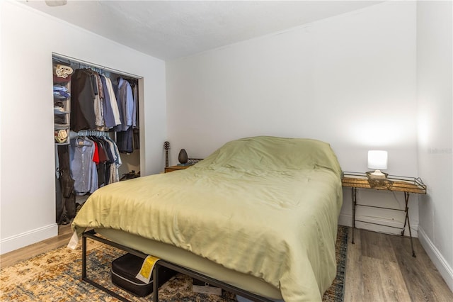 bedroom with a closet and hardwood / wood-style floors