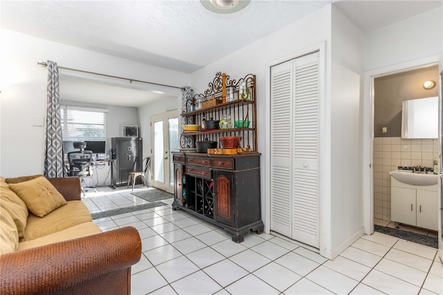 living room with light tile patterned flooring and sink