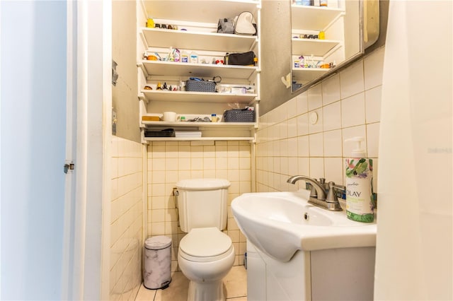 bathroom with vanity, toilet, tile walls, and tile patterned flooring