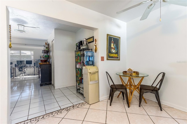 dining space featuring ceiling fan and light tile patterned floors