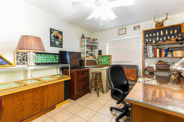 tiled office space featuring ceiling fan