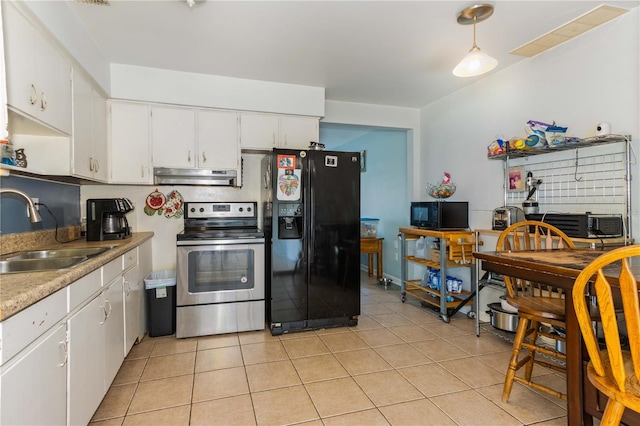 kitchen featuring light tile patterned floors, white cabinetry, black appliances, pendant lighting, and sink