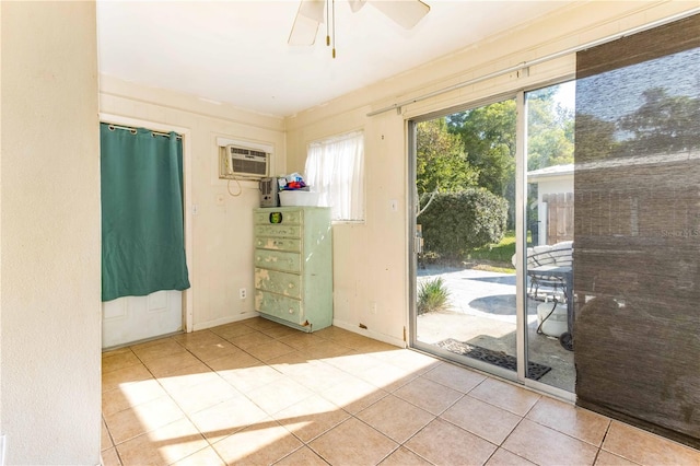 doorway to outside with a wall mounted air conditioner, ceiling fan, and light tile patterned floors