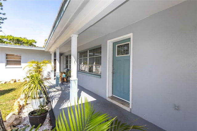 property entrance with covered porch