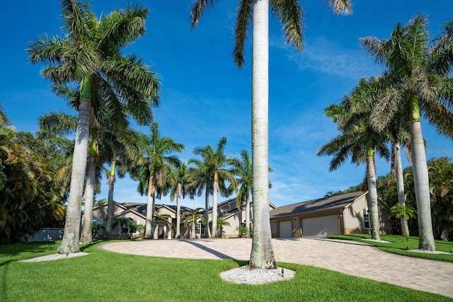 view of front facade with a front yard and a garage