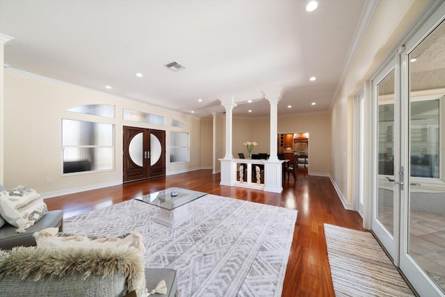 living room with french doors, dark hardwood / wood-style floors, ornate columns, and ornamental molding