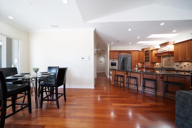 dining area with dark hardwood / wood-style flooring and a skylight