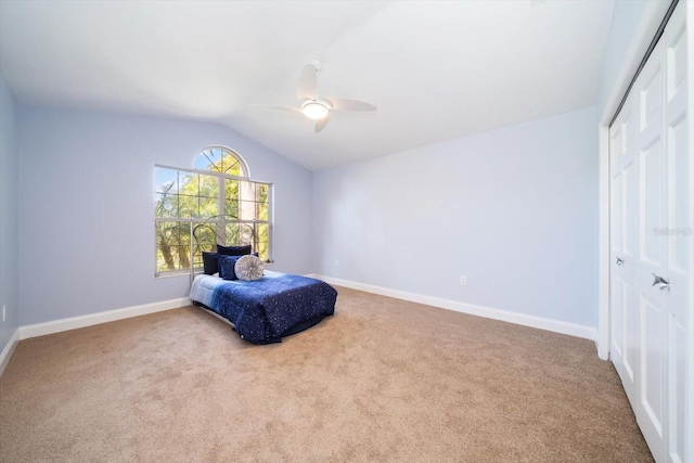 sitting room with lofted ceiling, ceiling fan, and light colored carpet