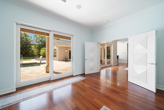 spare room with plenty of natural light, dark hardwood / wood-style floors, and crown molding