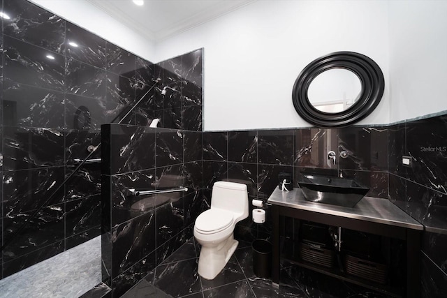 bathroom featuring vanity, a shower, toilet, and tile walls