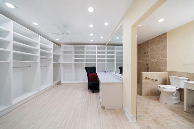 walk in closet with ceiling fan and light tile floors