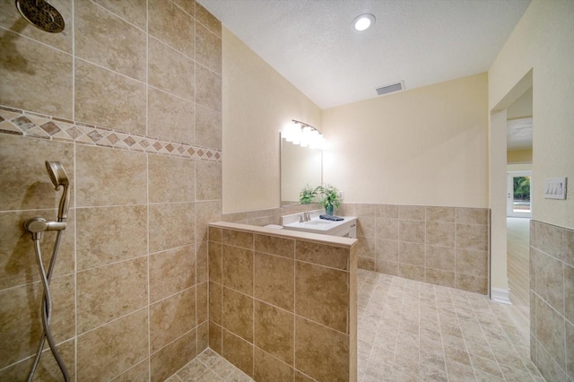 bathroom featuring a textured ceiling, independent shower and bath, and tile flooring