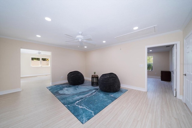 sitting room featuring ornamental molding and ceiling fan