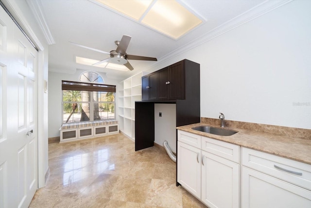 kitchen with ceiling fan, sink, light tile floors, dark brown cabinets, and white cabinetry