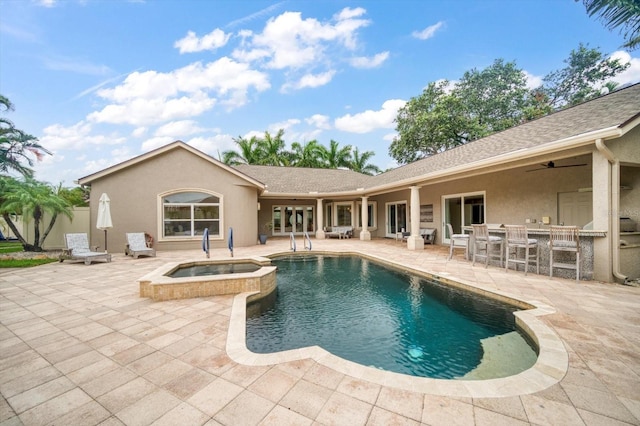 view of pool featuring a patio area, an in ground hot tub, and ceiling fan