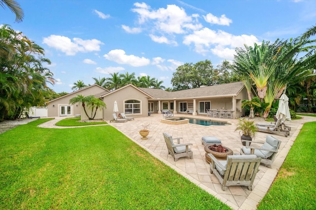 back of property with a patio area and a yard