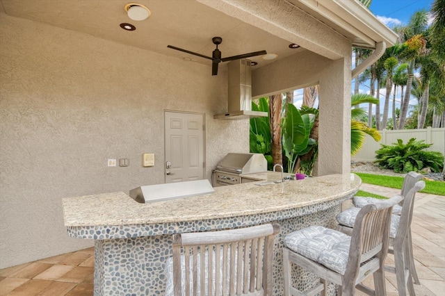 view of patio with an outdoor wet bar, grilling area, and an outdoor kitchen