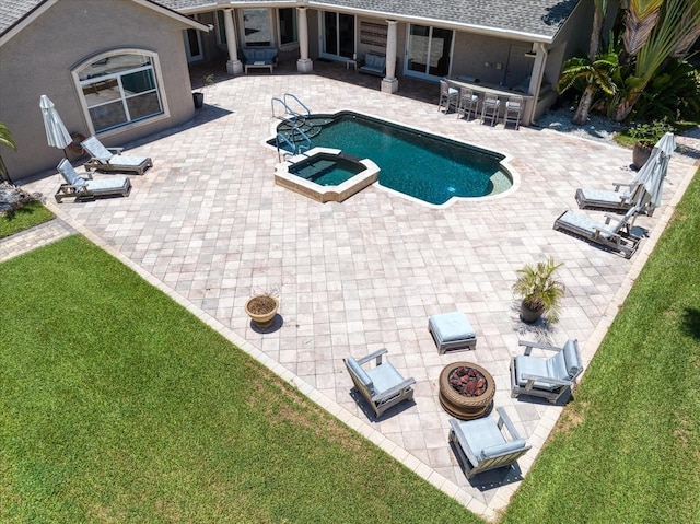 view of swimming pool with a lawn, a patio, and an in ground hot tub