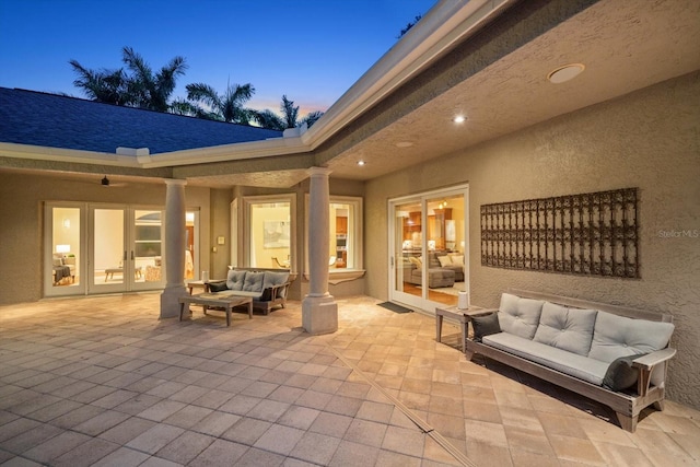 patio terrace at dusk with french doors and outdoor lounge area