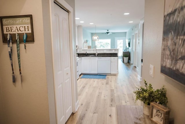 hall with sink and light hardwood / wood-style flooring