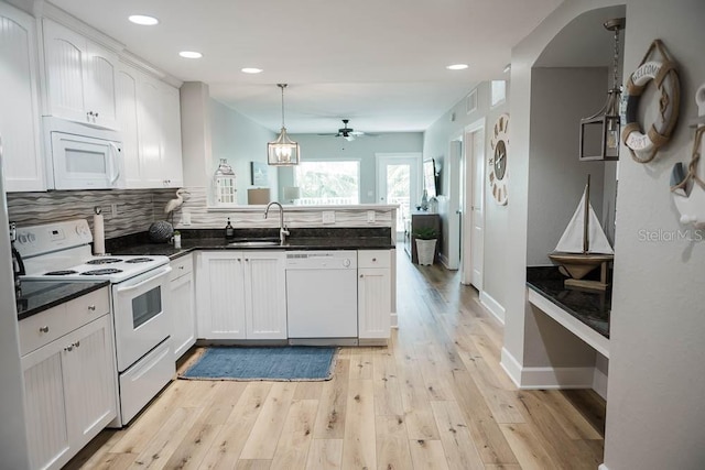 kitchen featuring white cabinetry, kitchen peninsula, hanging light fixtures, white appliances, and ceiling fan