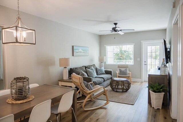 living room featuring ceiling fan and hardwood / wood-style floors